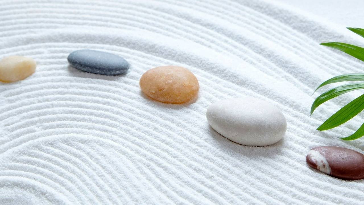 Stones aligned on sand in peaceful design