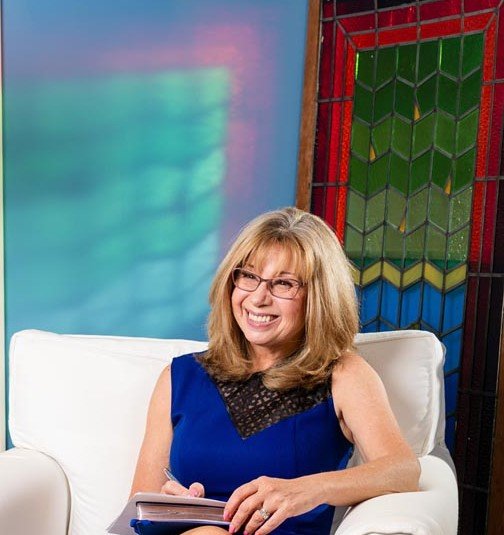 CarrieR in Chair smiling at Client 101323 096